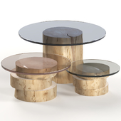 A set of light tables from stumps and slabs with glass tops.