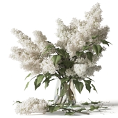Lilac branches in a glass vase bouquet