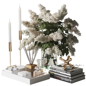Decorative set with a bouquet of lilacs in a glass vase