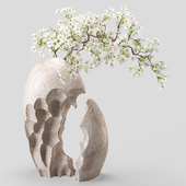 Flowering branch of decorative wild plum in a stone vase